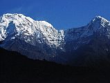 601 Annapurna South and Hiunchuli Early Morning From Past New Bridge After leaving New Bridge, I looked back to see Annapurna South and Hiunchuli glisten in the early morning sun.